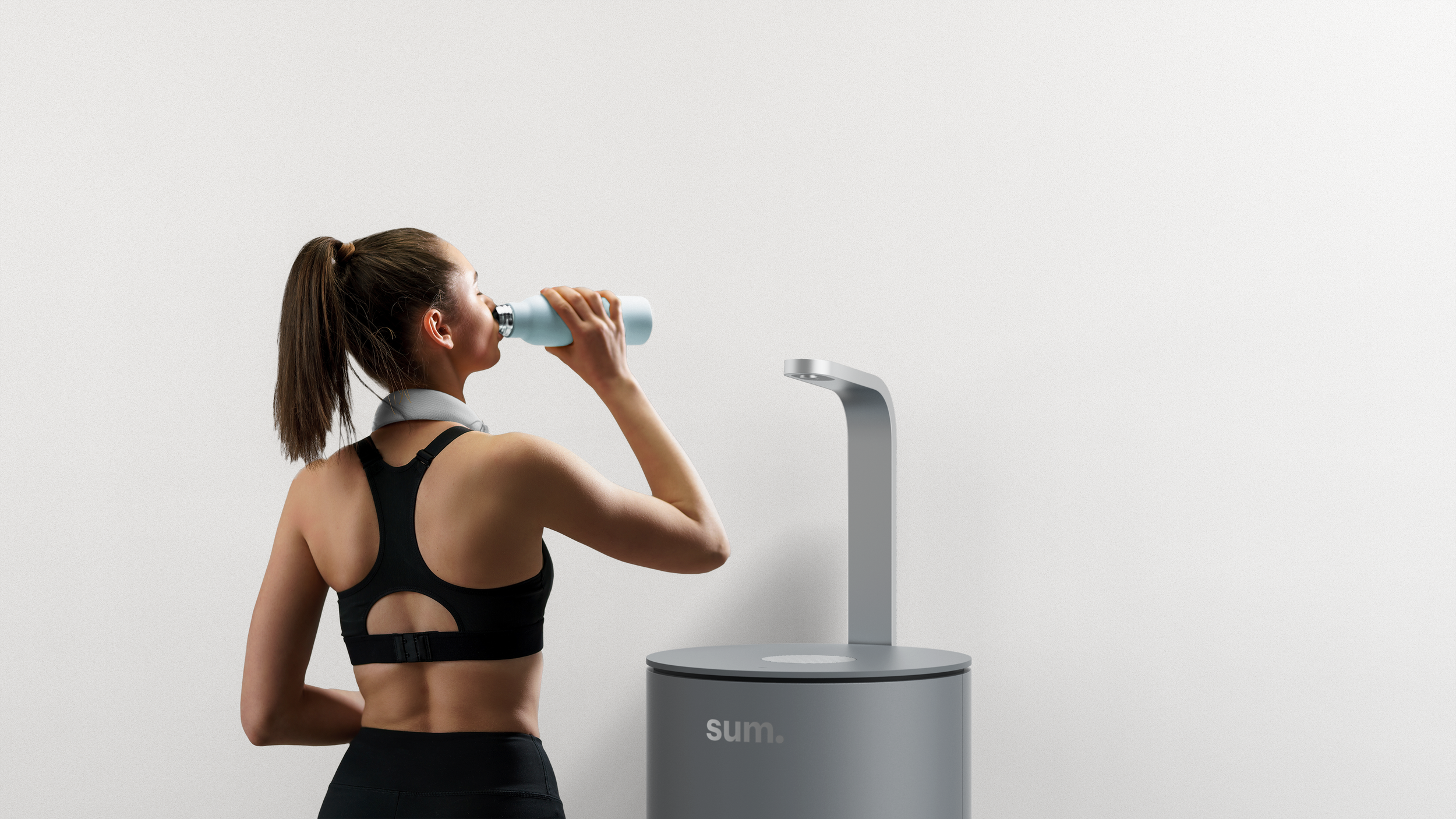 Woman drinking from sum dispenser